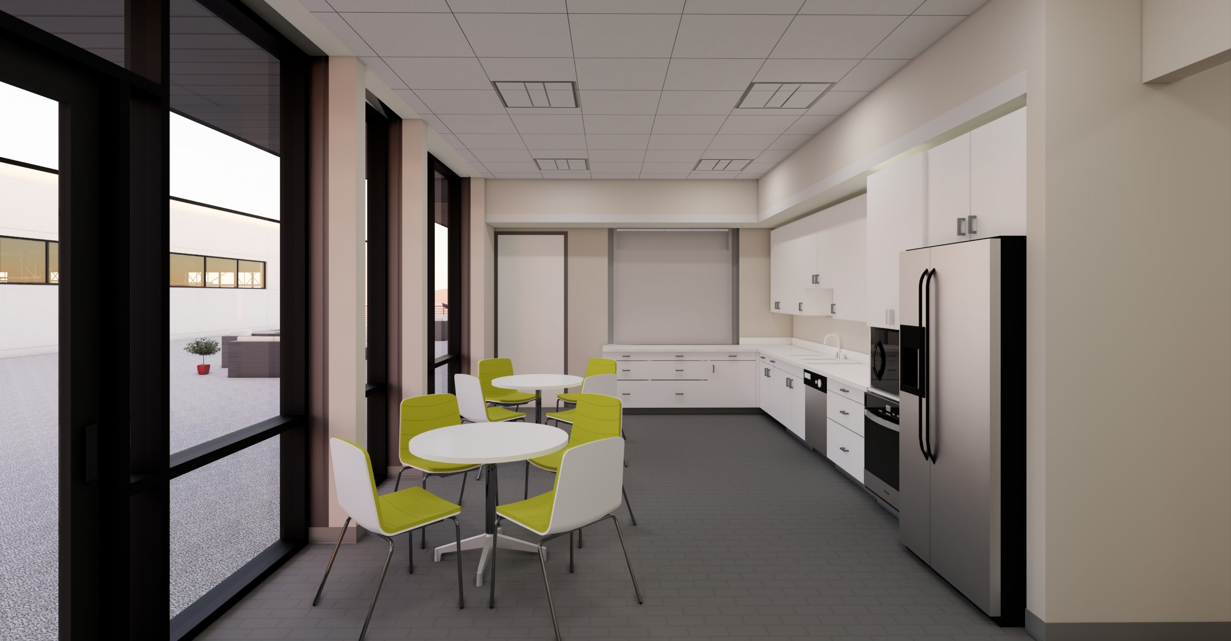 Bright, modern kitchen with white cabinetry, stainless steel appliances, and circular tables with green and white chairs. Large windows let in natural light.