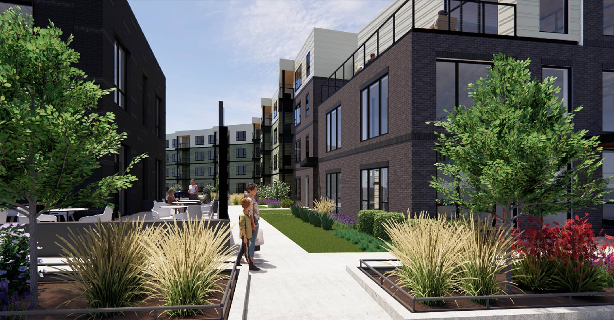 Modern apartment complex with dark brick facades, large windows, and rooftop patios. Lush landscaping with trees and plants lines the paved walkway.