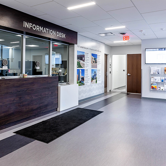 Renovated City Hall reception area with information counter, improved lighting, and clear wayfinding at Cedar Falls City Hall.