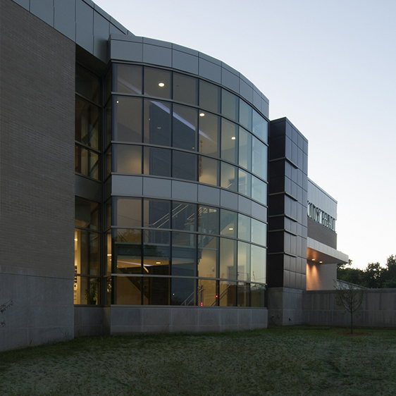 Curved glass façade of Hiawatha City Hall highlighting transparent public spaces and contemporary architectural detailing.