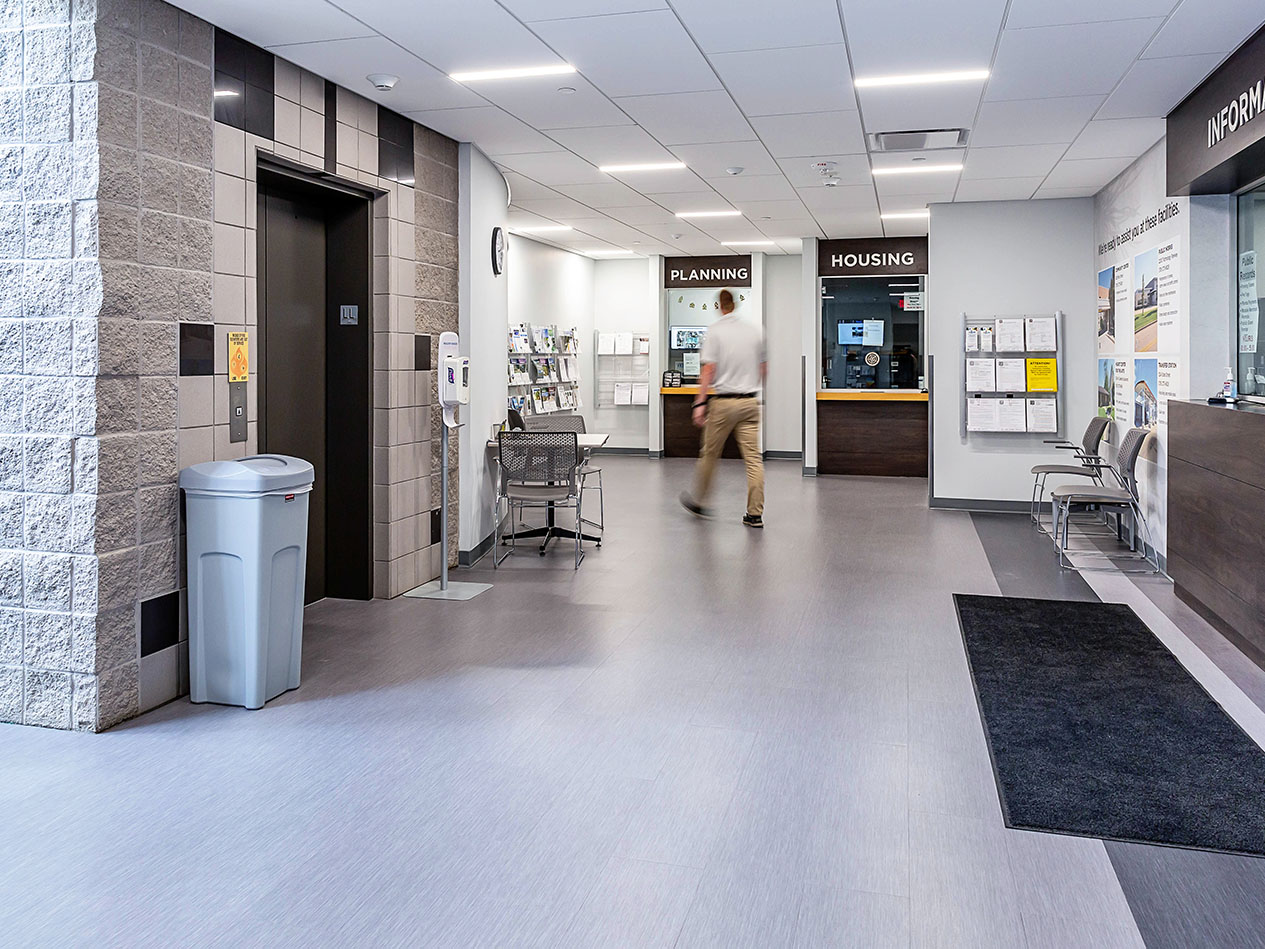 Interior view of Cedar Falls City Hall showing renovated public corridor with modern finishes and wayfinding.