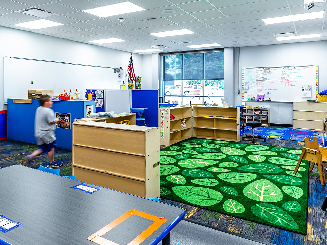 Classroom with students and playful carpet