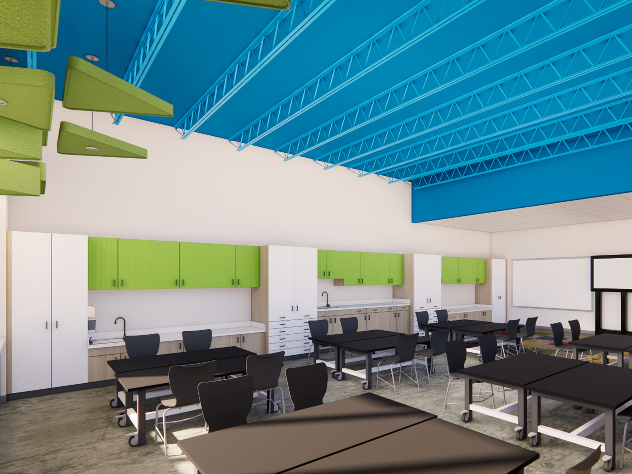 Elementary school art classroom with worktables, built-in storage, sinks, and exposed blue ceiling structure at Decorah Community School District.