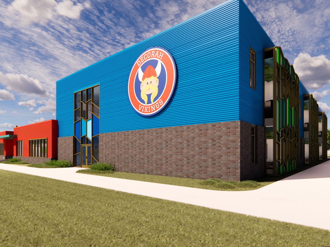 Elementary school gymnasium exterior with blue metal siding and Decorah Vikings logo.