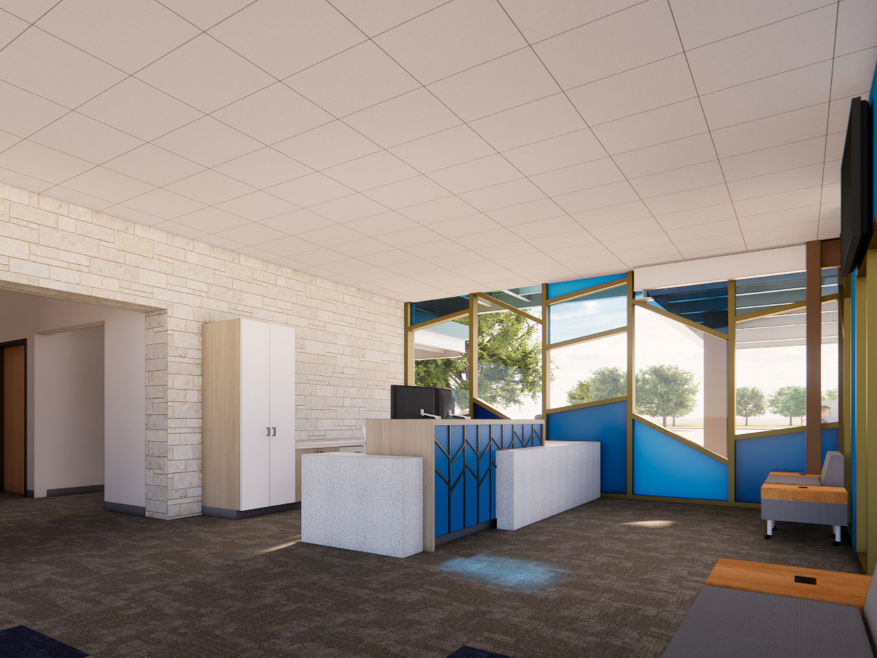 Elementary school main office with secure reception desk, natural stone wall, and clear sightlines to entry.