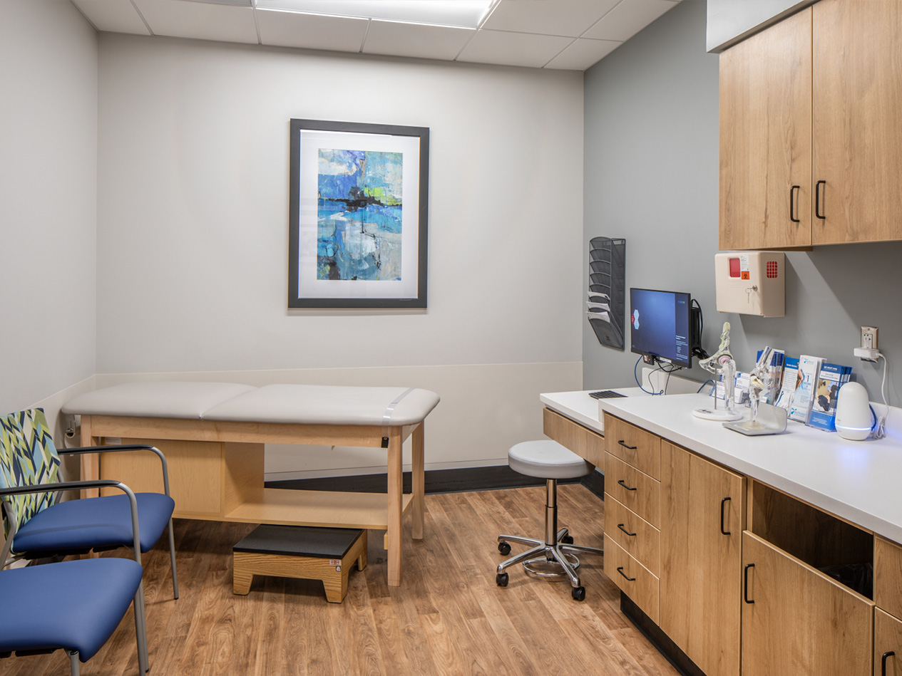Clinical workroom at MD West One Fountain Ridge with built-in casework, computer workstation, and exam support areas.