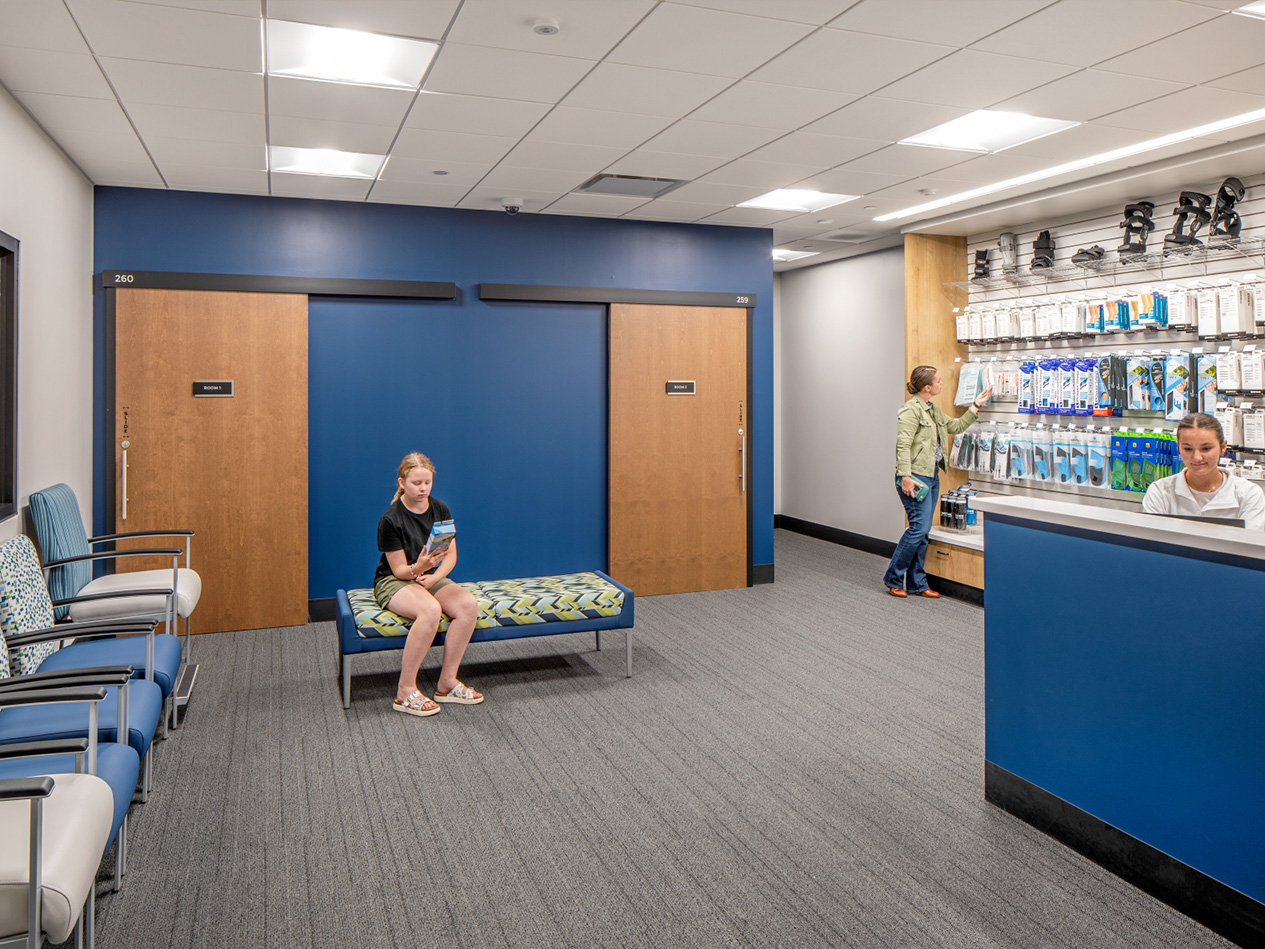 Patient waiting area at MD West One Fountain Ridge with seating, retail display, and reception counter.