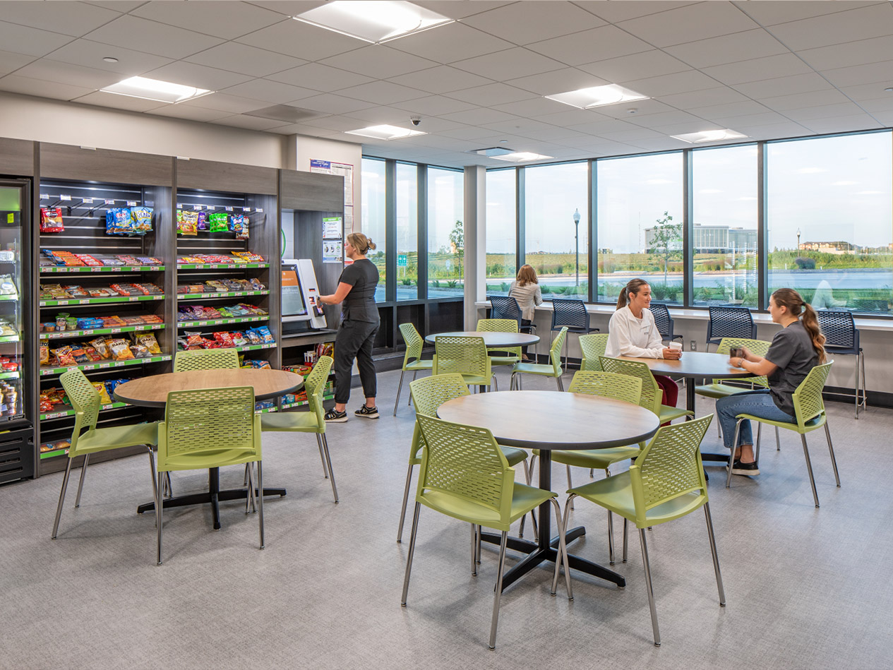 Staff break area with café-style seating and vending options inside the MD West One Fountain Ridge clinic.