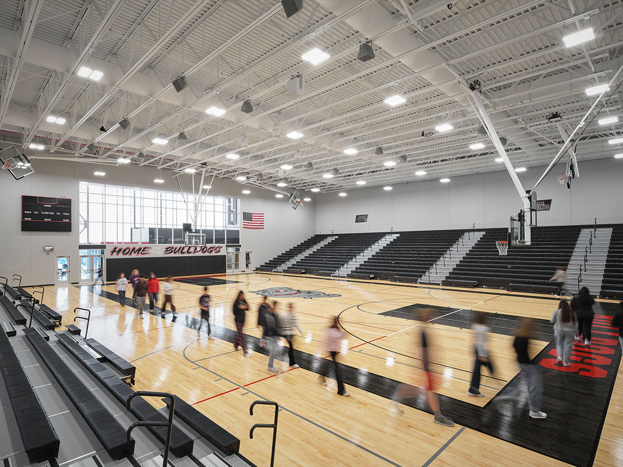 Elevated view of gymnasium during a school event with students on the basketball court.