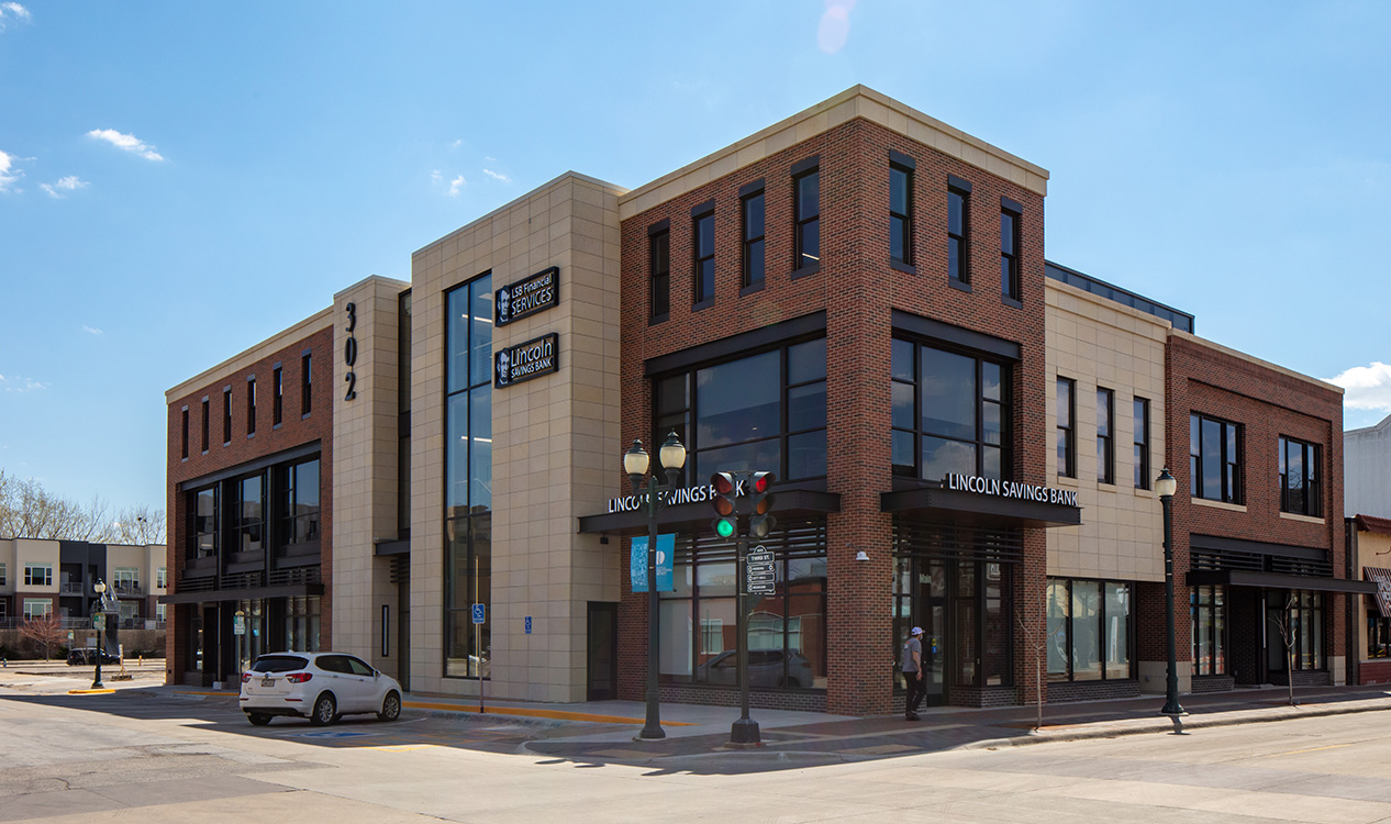 Corner view of the 302 Main Street Building featuring contemporary architecture and street-level retail space in Cedar Falls.