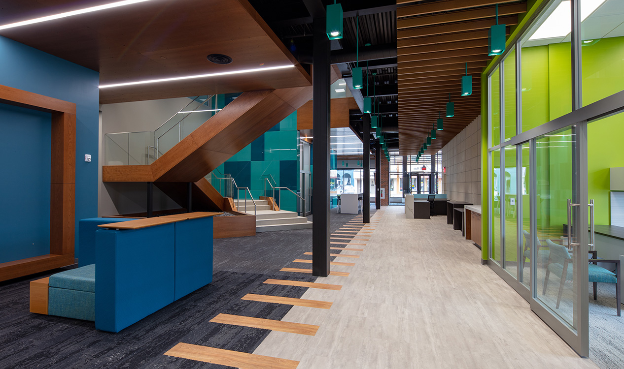 Modern office interior at the 302 Main Street Building with collaborative workspaces, wood accents, and glass-front offices.