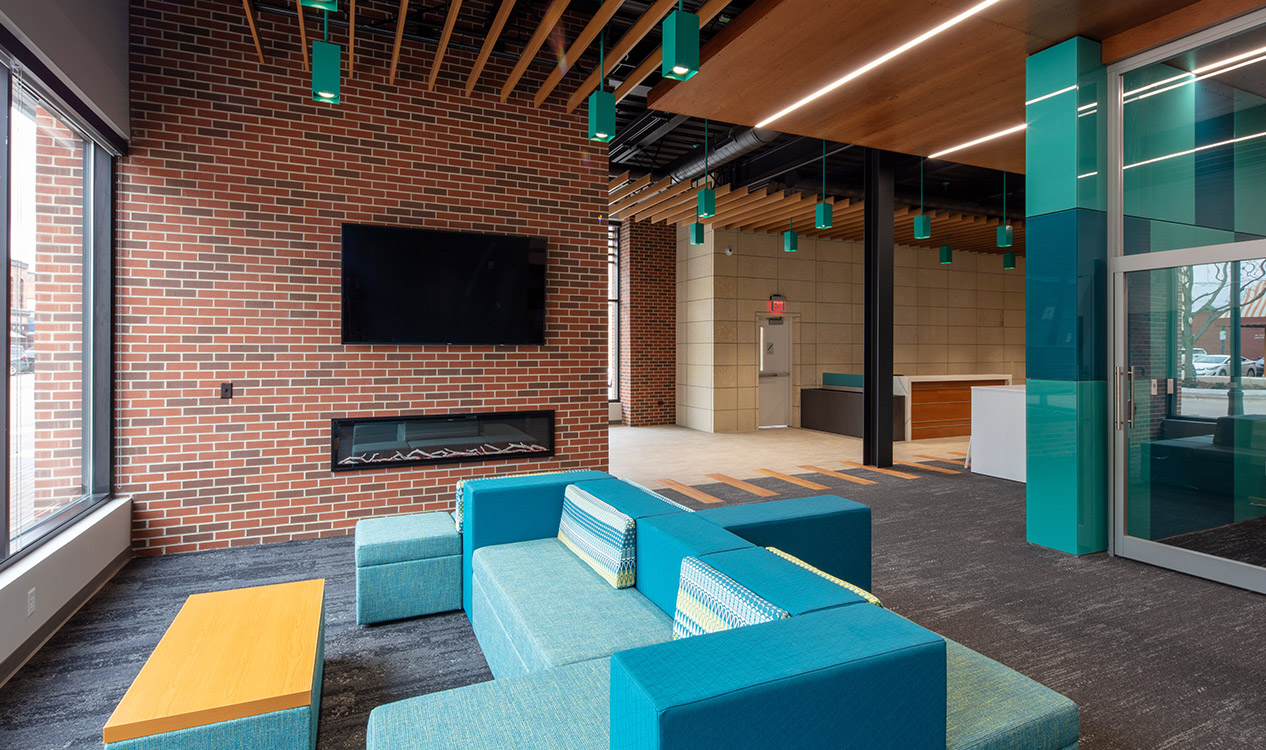 Employee lounge and collaboration area within the 302 Main Street Building featuring flexible seating and exposed brick walls.