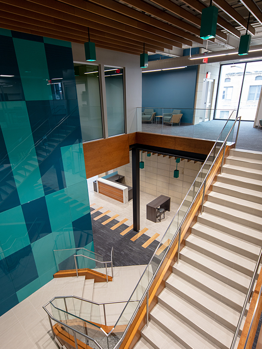 Open stairway and atrium connecting office levels within the 302 Main Street Building in Cedar Falls, Iowa.