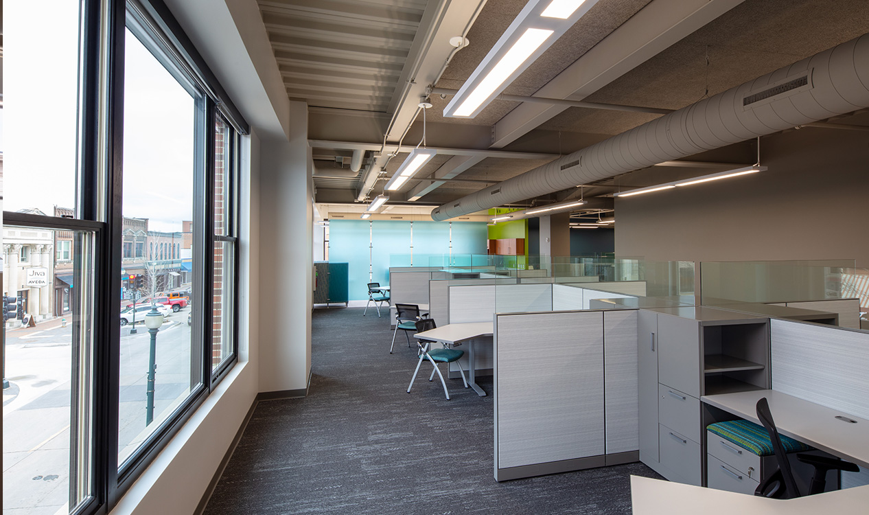 Modern office suite with expansive windows, collaborative work areas, and downtown views inside the 302 Main Street Building.