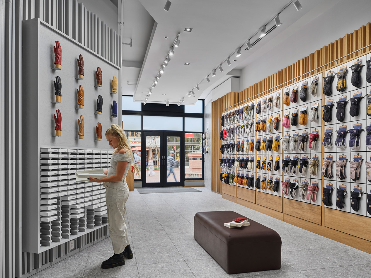 Hestra retail store design featuring organized glove displays, wood detailing, and open customer circulation