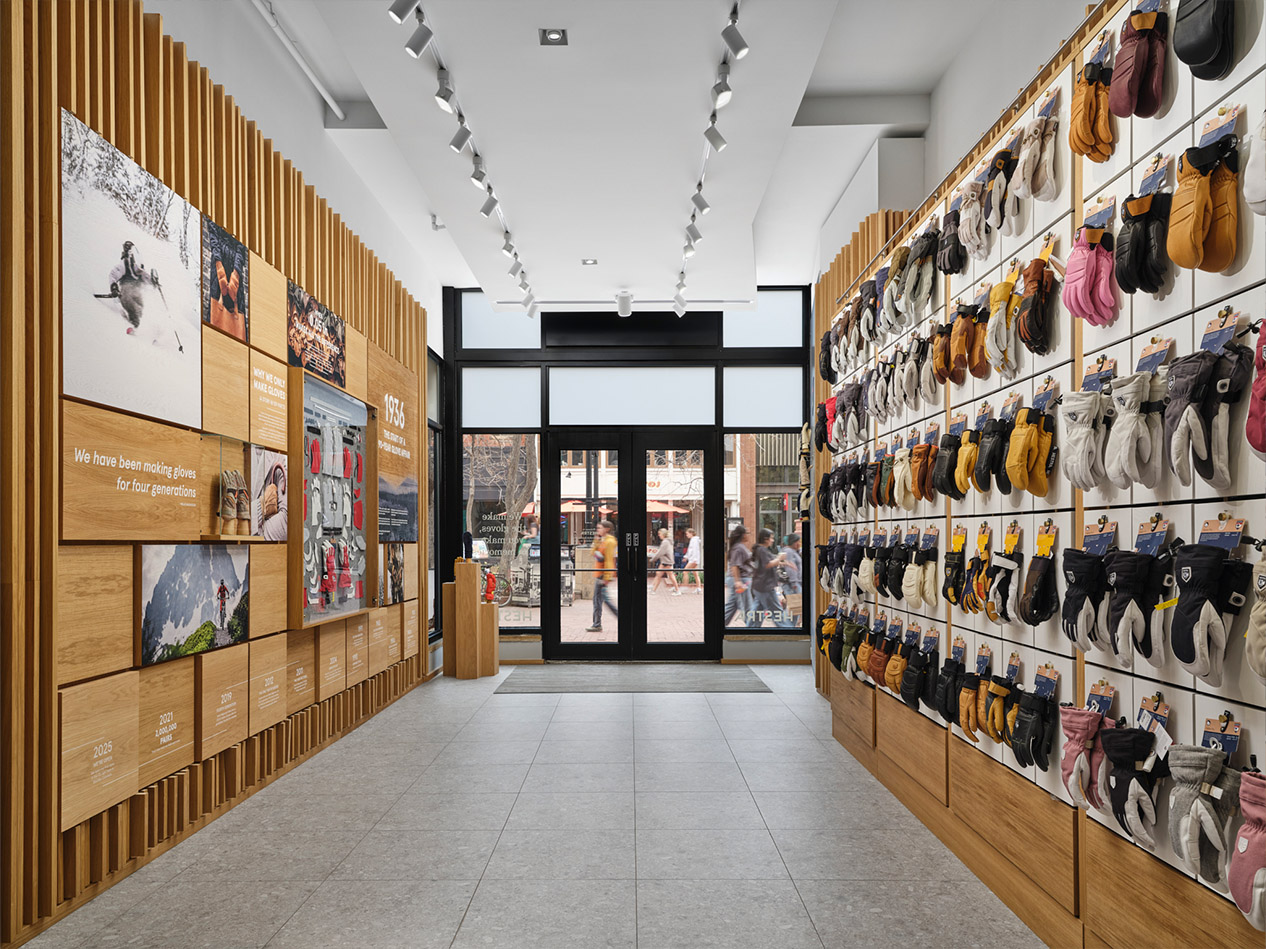Hestra retail store design hallway with brand storytelling wall and glove merchandising displays