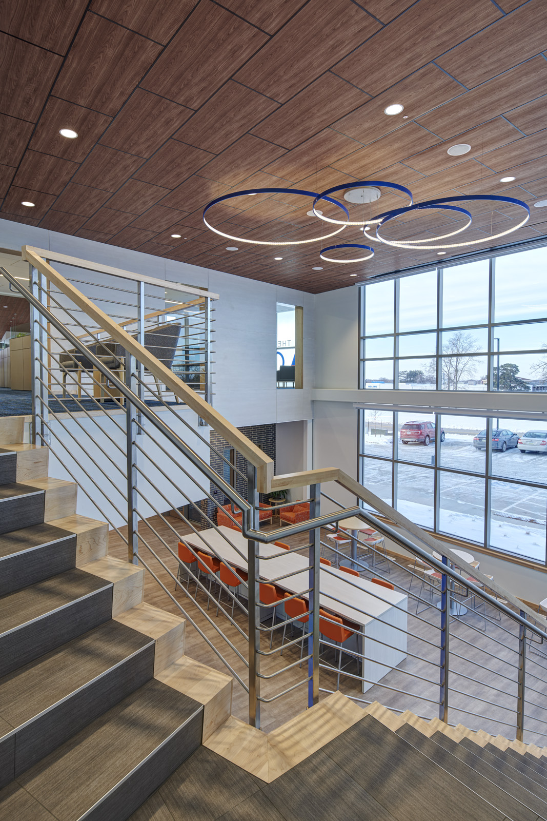 Architectural staircase detail with custom railing and views across the office.