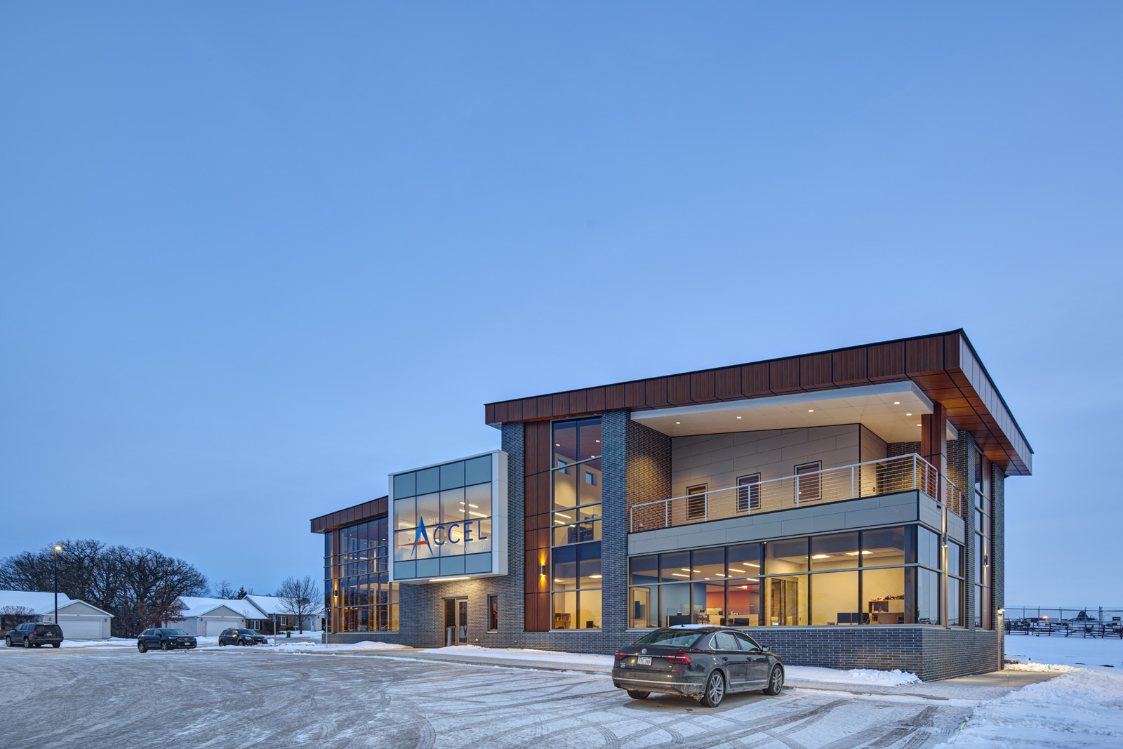 Exterior view of The Accel Group headquarters in Waverly, Iowa, at dusk.