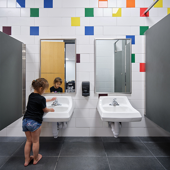 Child-friendly restroom inside the Riceville Daycare Addition with colorful design elements