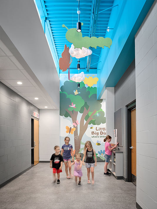Children entering the Riceville Daycare Addition through a welcoming learning corridor
