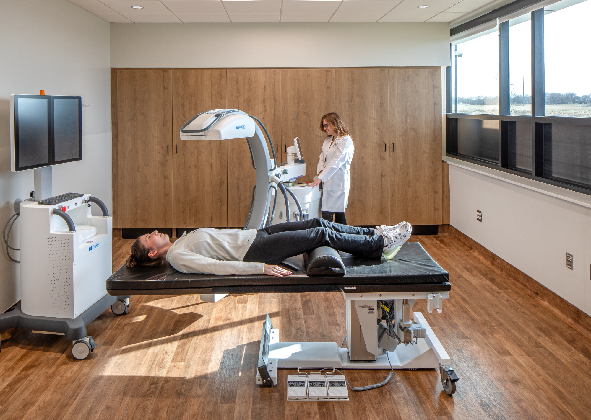 Medical imaging room at MD West ONE featuring diagnostic equipment, warm wood finishes, and natural light in a modern clinical setting.